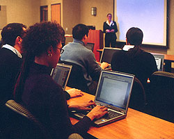 Students using laptop computers in class.