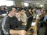 Screen shot from video, students working on computers in a classroom
