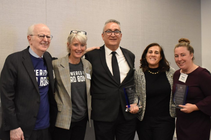 Five people pose for a picture together at the 10th anniversary of the pro bono program.