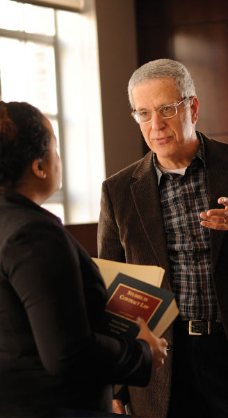 Professor Andrew Schepard speaking with a law student