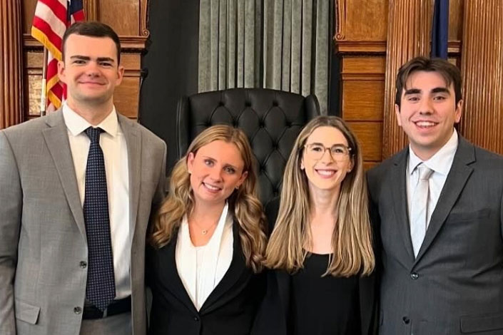 Group photo of Sydney Albert (3L), Brian O’Regan (3L), Caitlin McDonough (2L), and Anthony Gazzola (1L)  at the 2024 Syracuse National Trial Competition in Syracuse, NY.