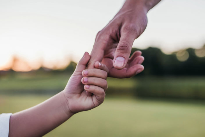 Parent and child holding hands