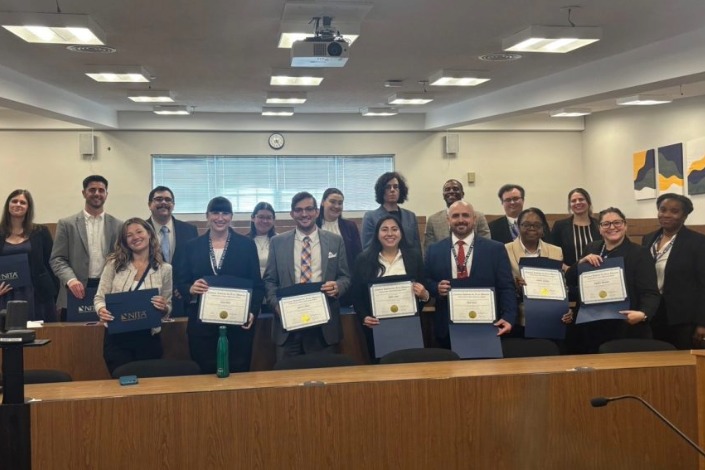 Group of training participants hold their certificates of completion.