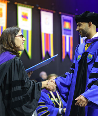 Dean Roberts and Student at Graduation