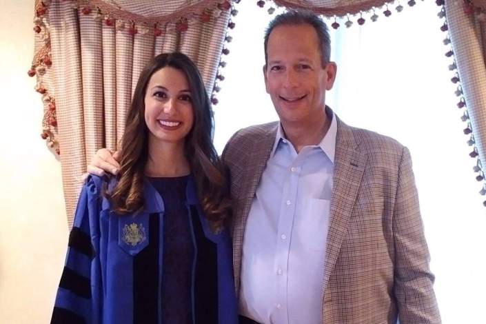 A photo of Hofstra Law alumnus Steven Levitt ’81 and his daughter, who is wearing law school commencement regalia.