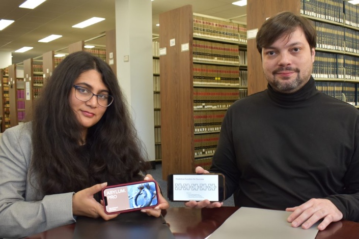 Two Hofstra Law students show their project from the National Legal Innovation Tournament.