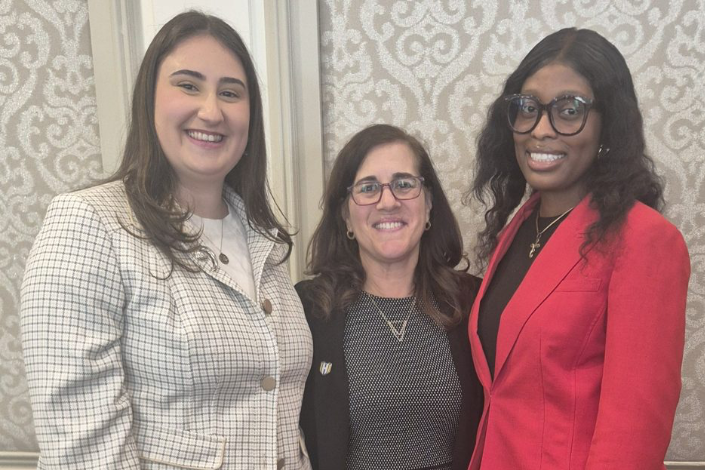 Two Hofstra Law student scholarship recipients pose for a picture with Dean Jenny Roberts.