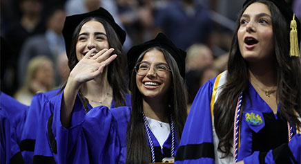 Photo from the commencement ceremony of three graduates.